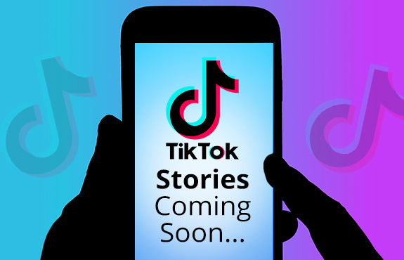 Silhouetted Hands Holding Phone On TikTok App That's Launching Stories Feature Coming Soon