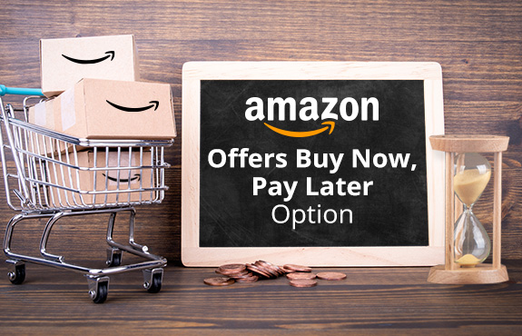 Shopping Cart Loaded With Amazon Boxes Next to Hourglass Which You Can Now Pay Later At Checkout