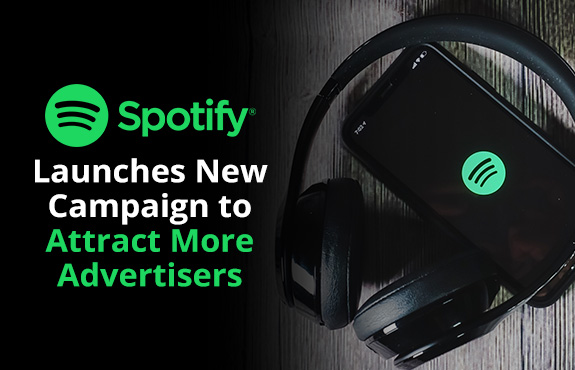 Headphones Underneath iPhone Displaying Spotify Logo as They Launch Campaign to Attract More Advertisers